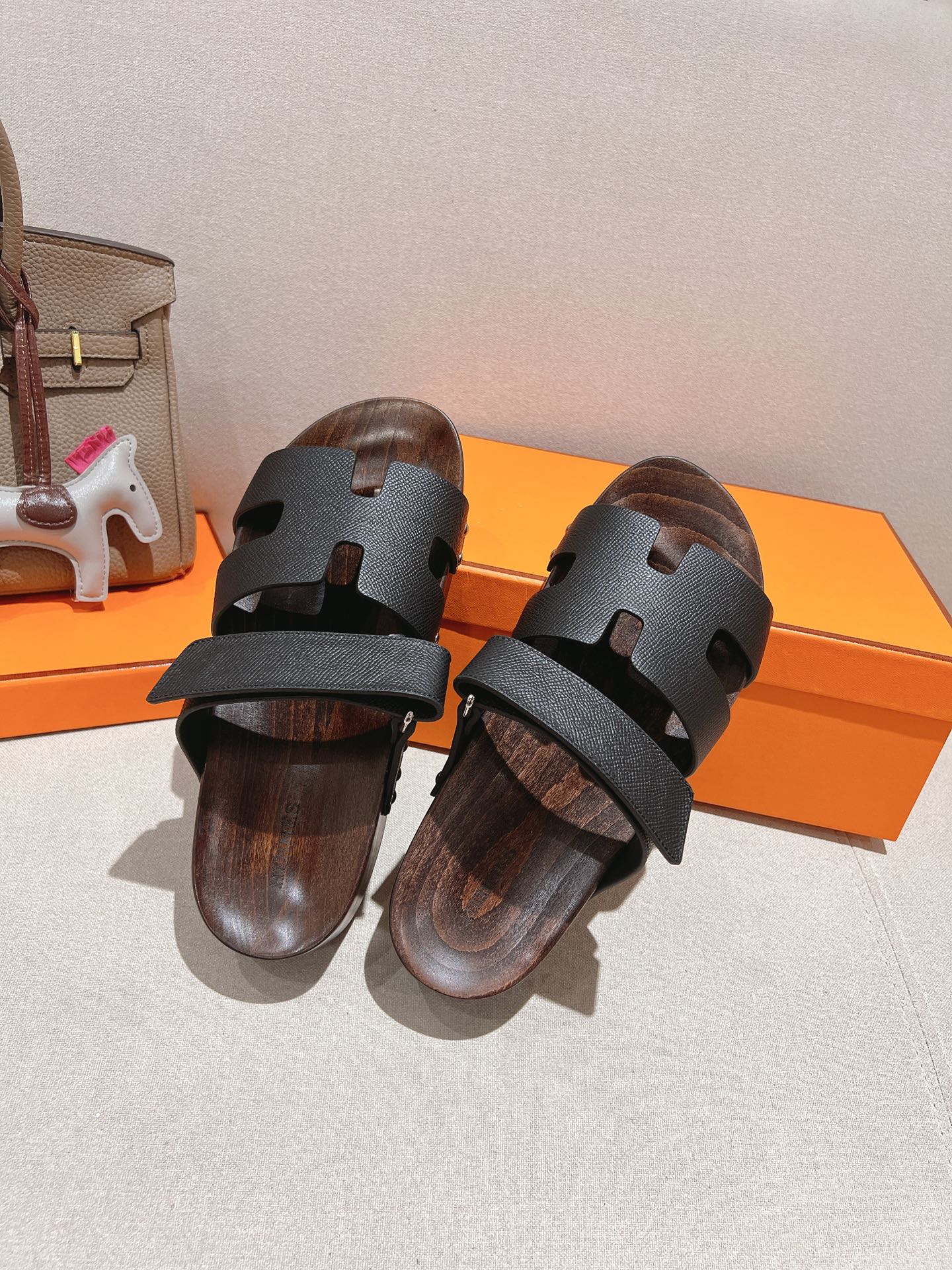 Black Hermes Ankara leather slippers with brown patterned sole