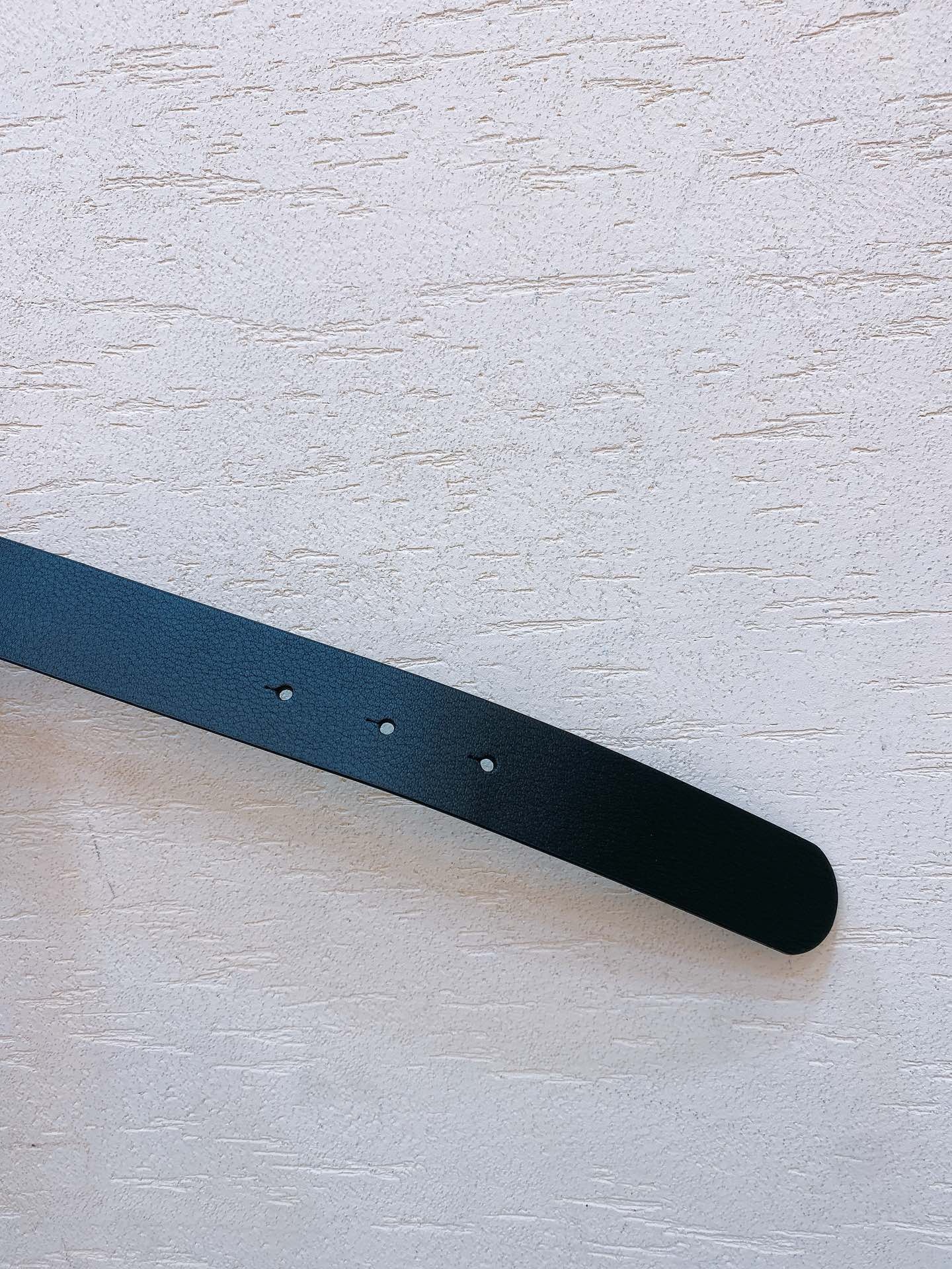 Black leather belt with gold metal buckle engraved with Miu Miu