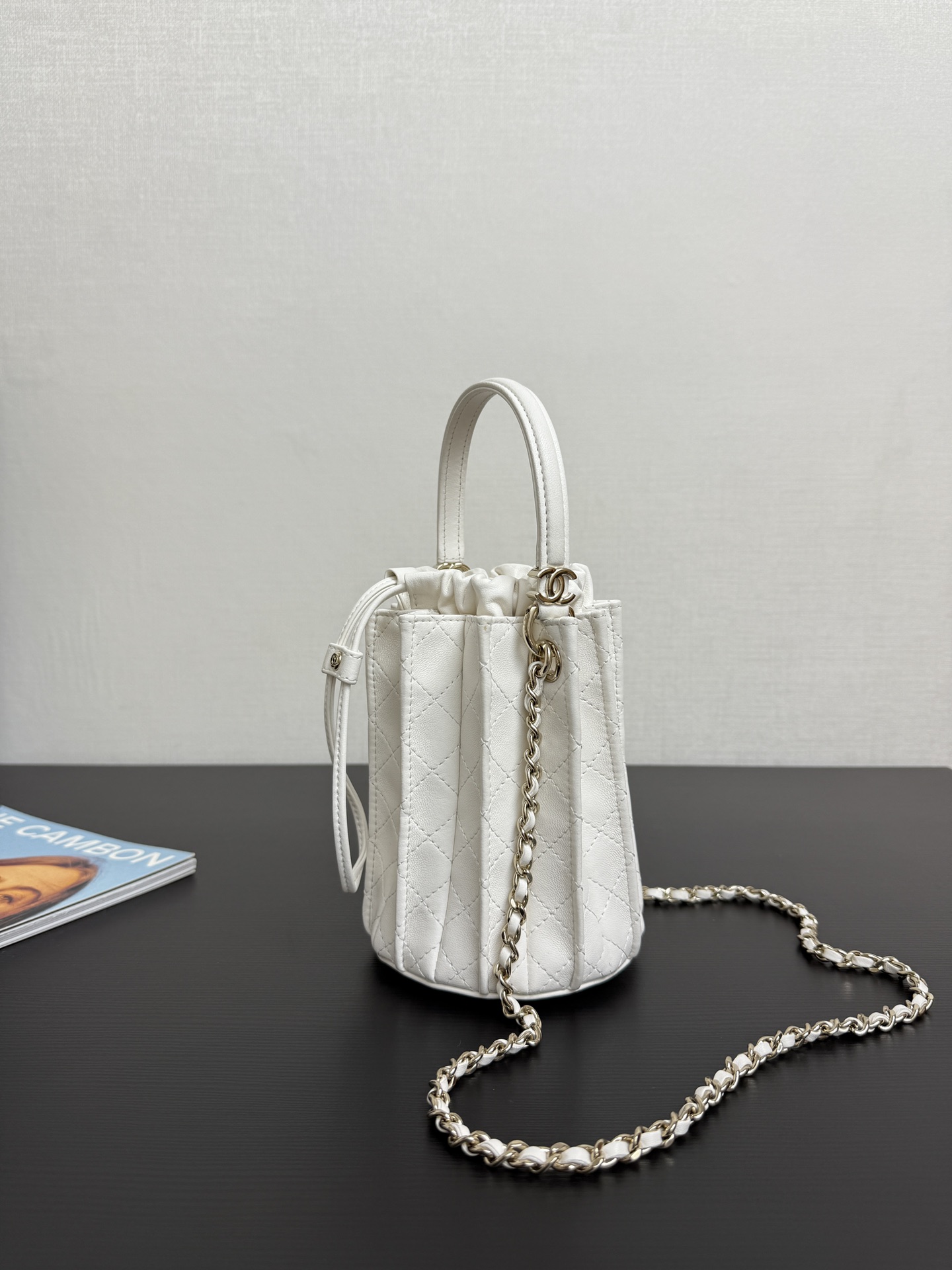 Chanel Mini bucket bag, Lambskin & gold-tone metal, white