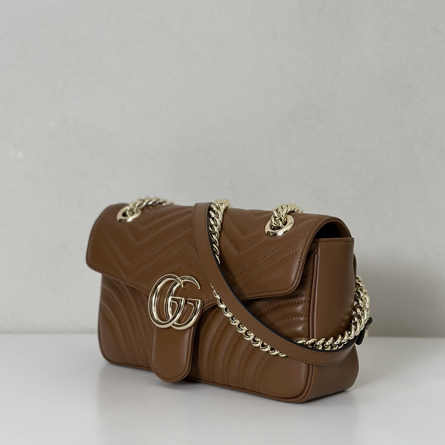 GG Marmont small shoulder bag in Gold Leather | GUCCI