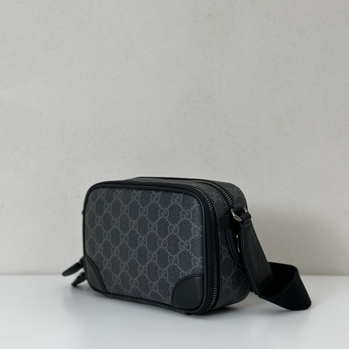 GUCCI  GG Emblem small crossbody bag in black fabric | GUCCI