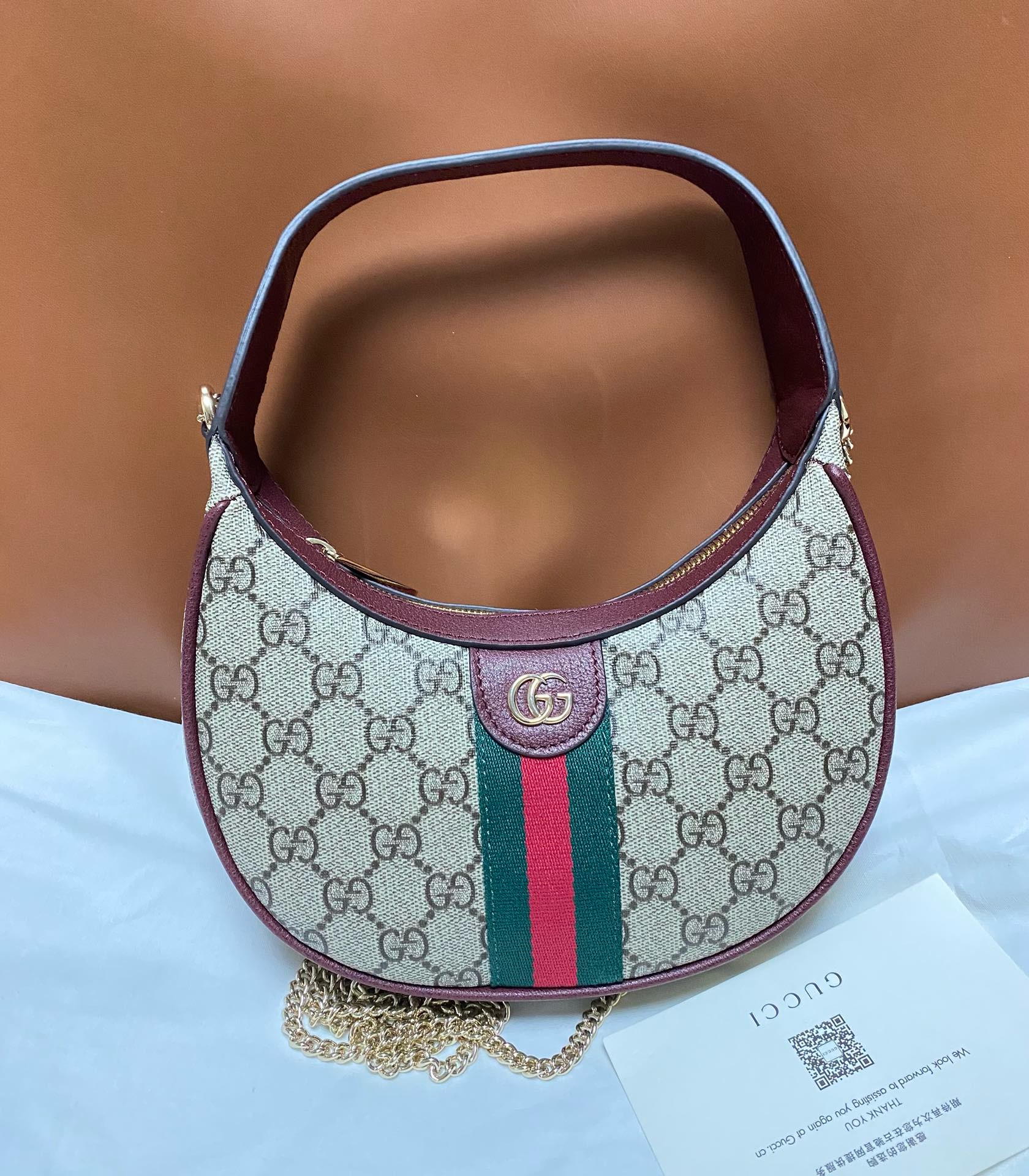 Gucci Ophidia Mini Crescent Bag in GG Supreme canvas with green and red Web stripe and burgundy leather trim
