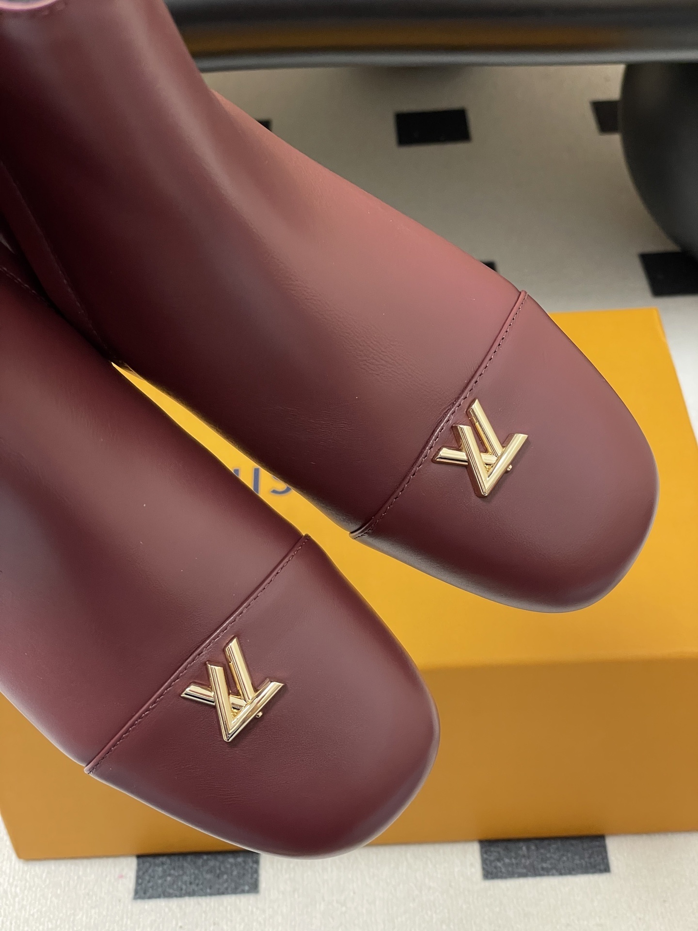 Elegant Burgundy Leather Ankle Boots with Gold LV Logo Ornament