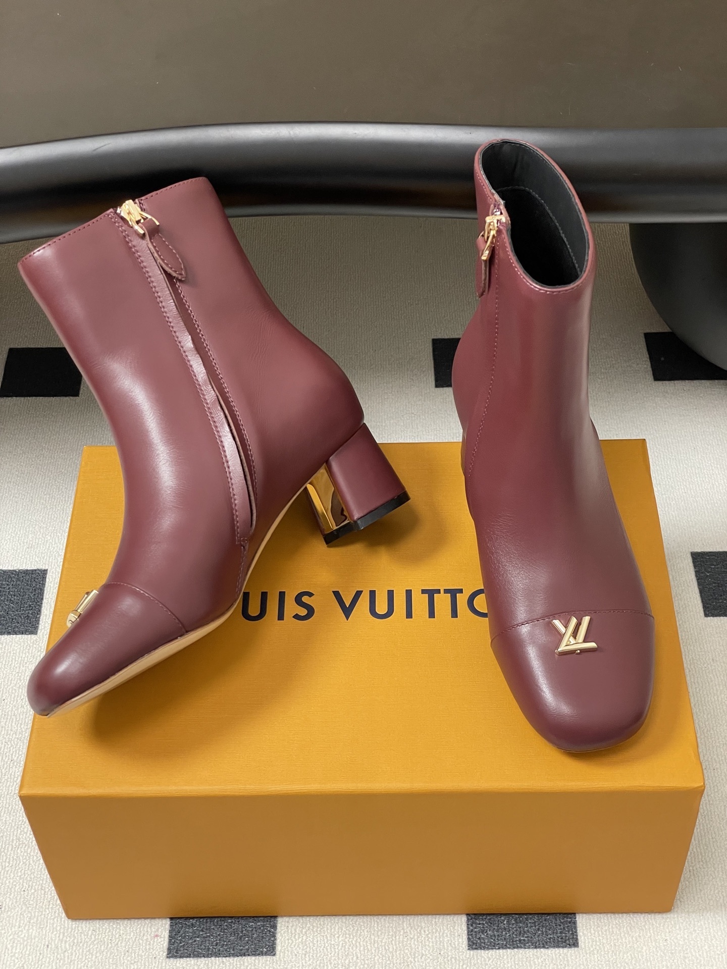 Elegant Burgundy Leather Ankle Boots with Gold LV Logo Ornament