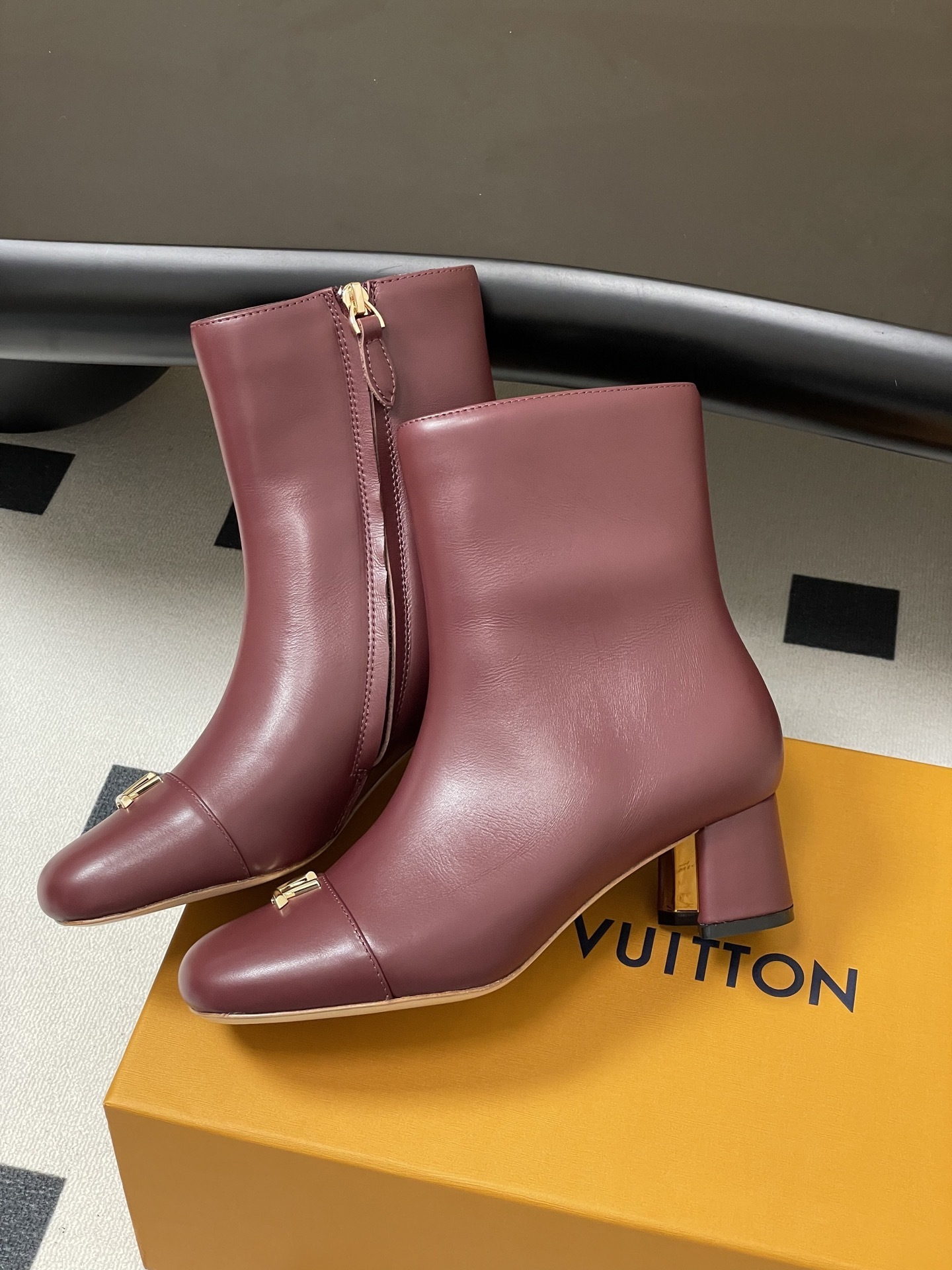 Elegant Burgundy Leather Ankle Boots with Gold LV Logo Ornament