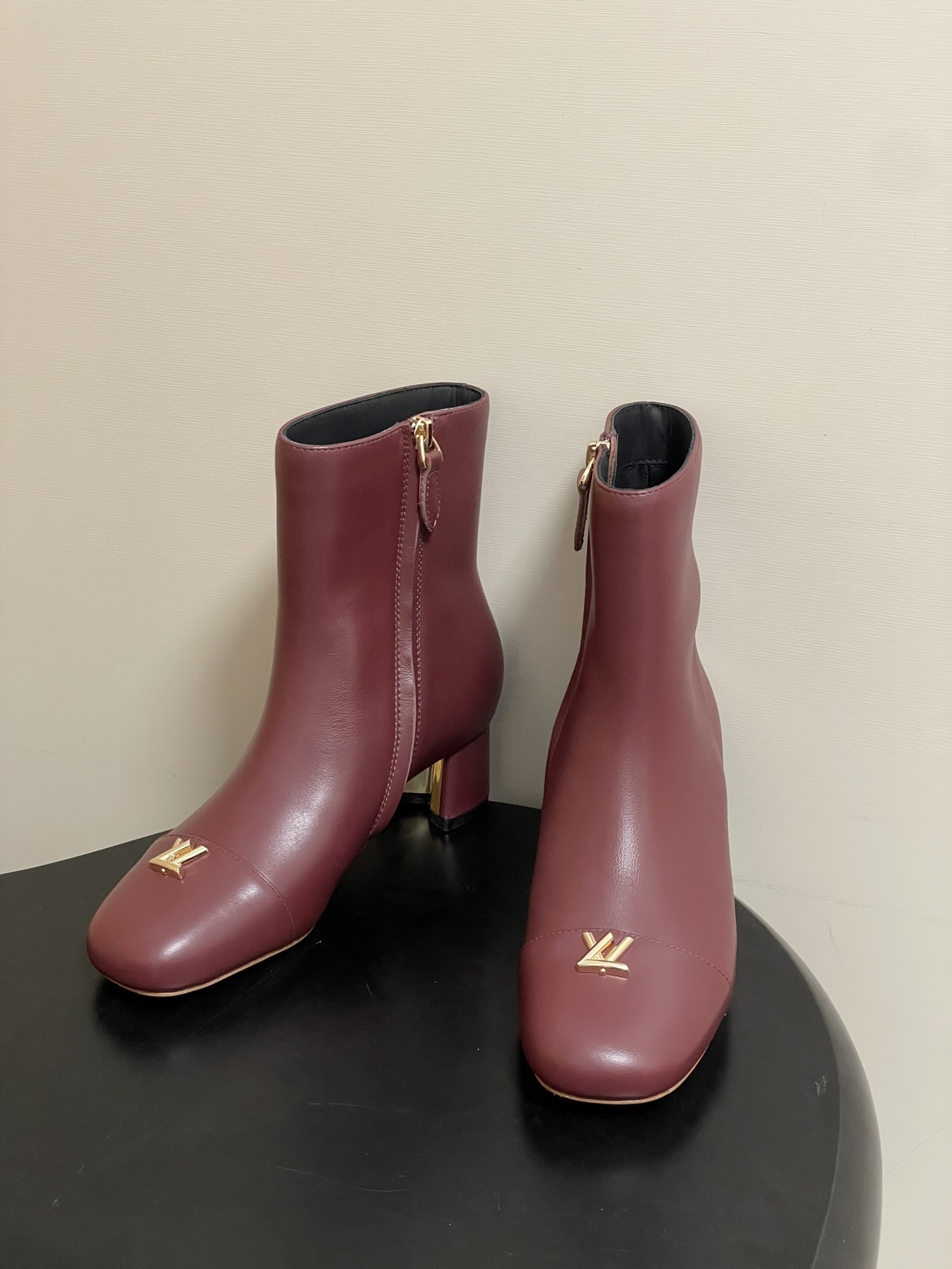 Elegant Burgundy Leather Ankle Boots with Gold LV Logo Ornament