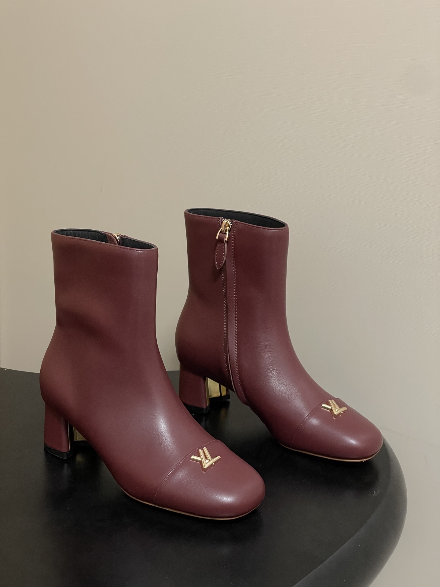 Elegant Burgundy Leather Ankle Boots with Gold LV Logo Ornament