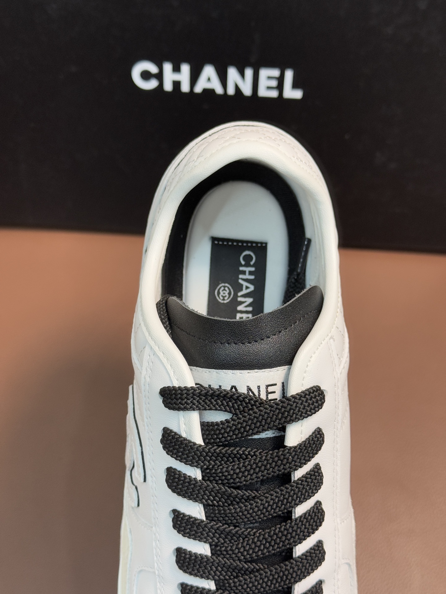 Chanel Luxury White Leather Sneakers with Black CC Logo Detail