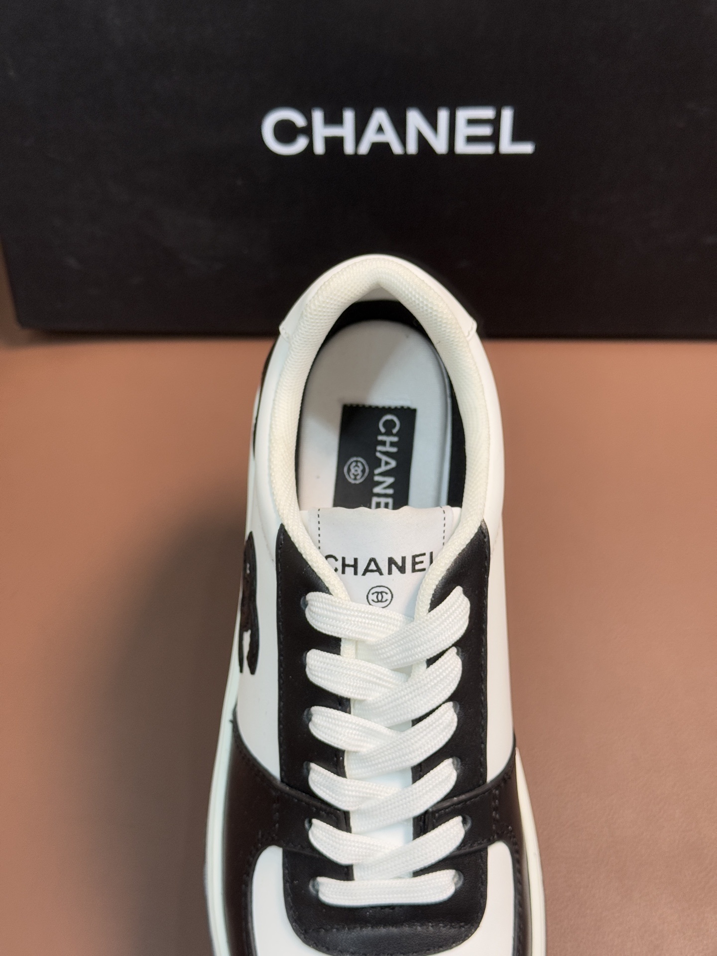 Chanel Luxury Black and White Leather Sneakers with CC Logo