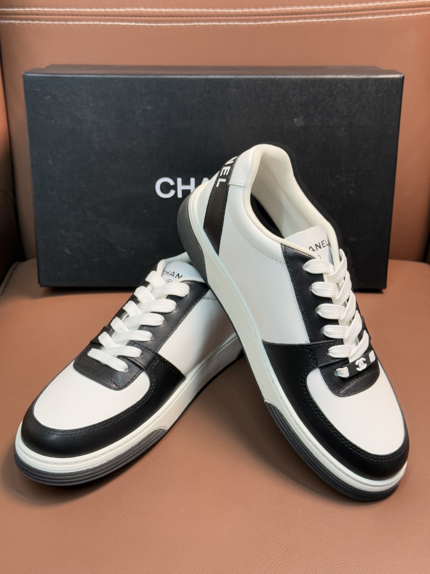 Chanel Luxury Black and White Leather Sneakers with CC Logo