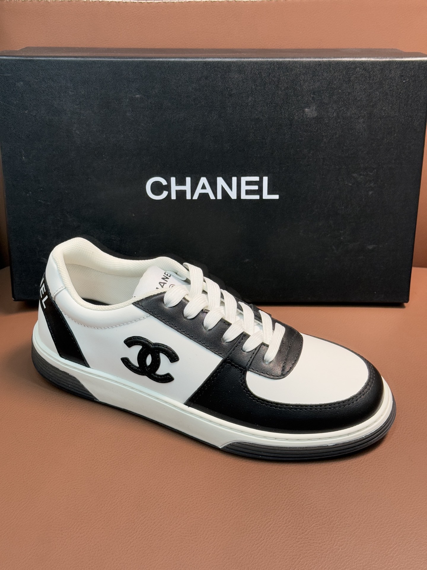 Chanel Luxury Black and White Leather Sneakers with CC Logo
