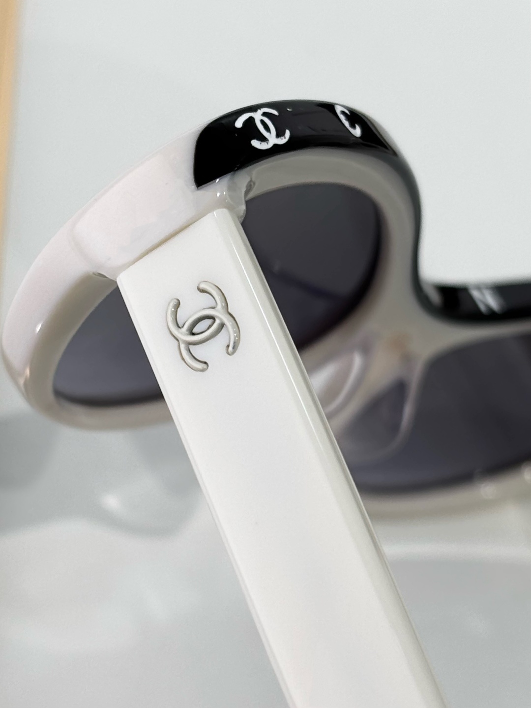 Chanel Luxury Oval Sunglasses - White Acetate with Black Logo Rim