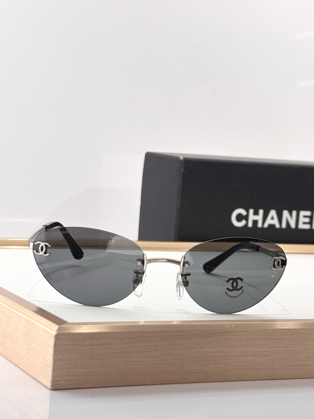 Chanel Luxury Rimless Sunglasses - Blue Tinted Lenses & Silver Logo