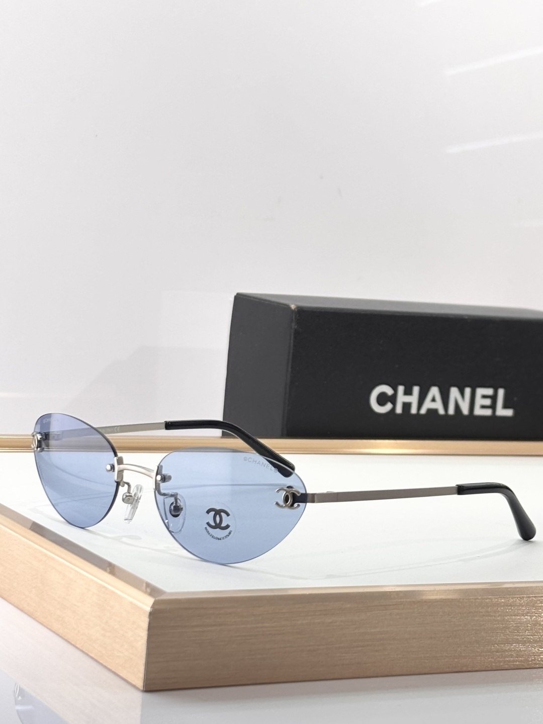 Chanel Luxury Rimless Sunglasses - Blue Tinted Lenses & Silver Logo