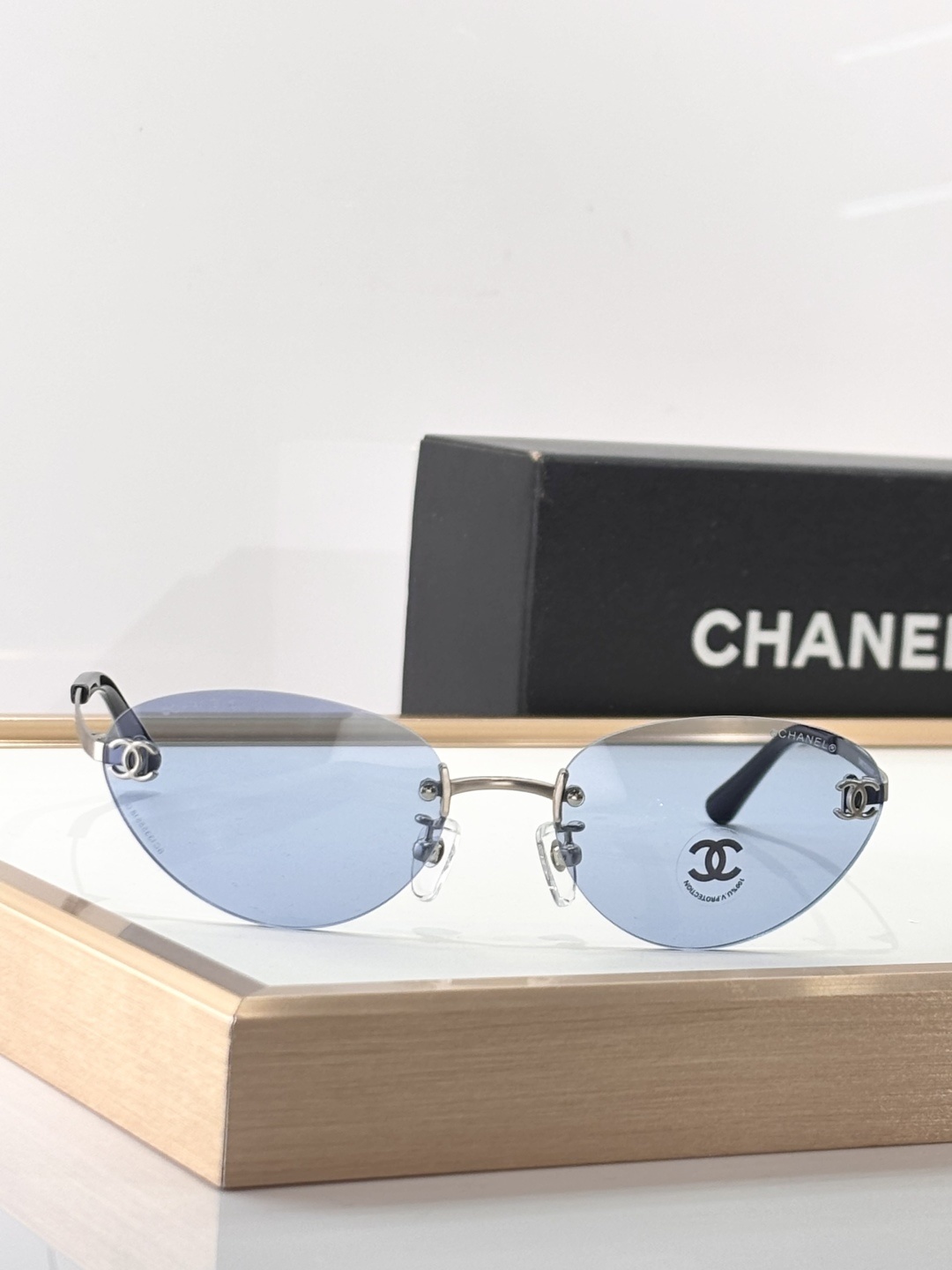 Chanel Luxury Rimless Sunglasses – Blue Tinted Lenses & Silver Logo