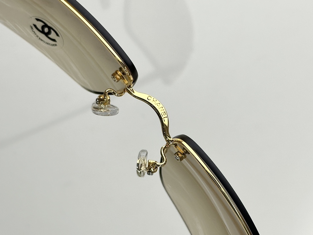 Chanel Luxury Rimless Sunglasses with Crystal CC Logo & Brown Lenses