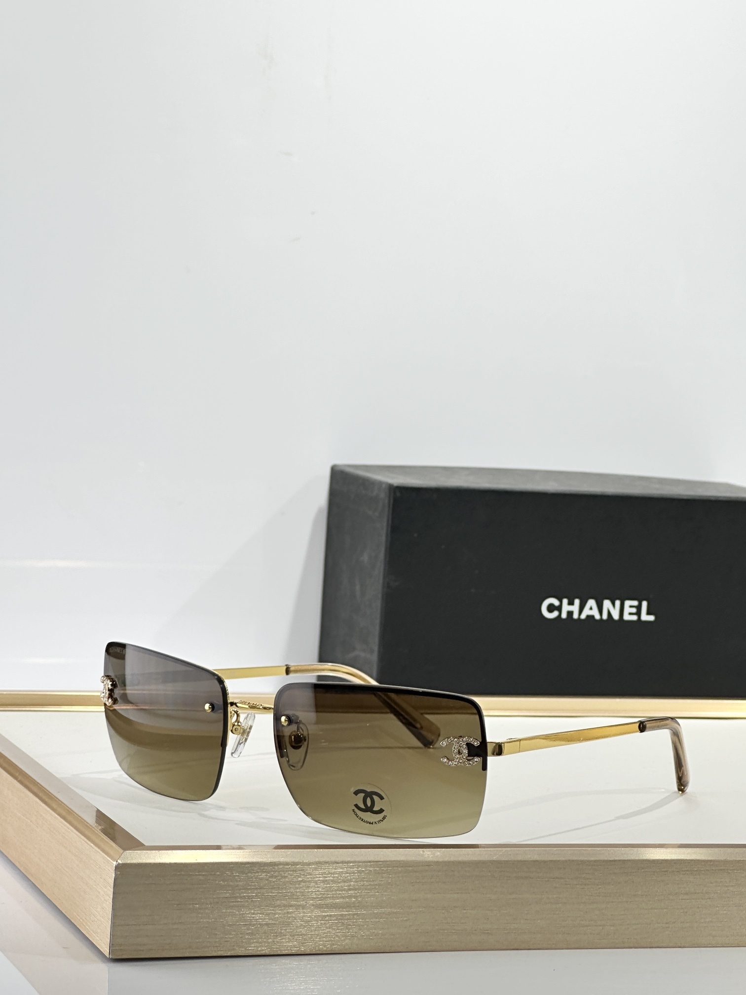 Chanel Luxury Rimless Sunglasses with Crystal CC Logo & Brown Lenses