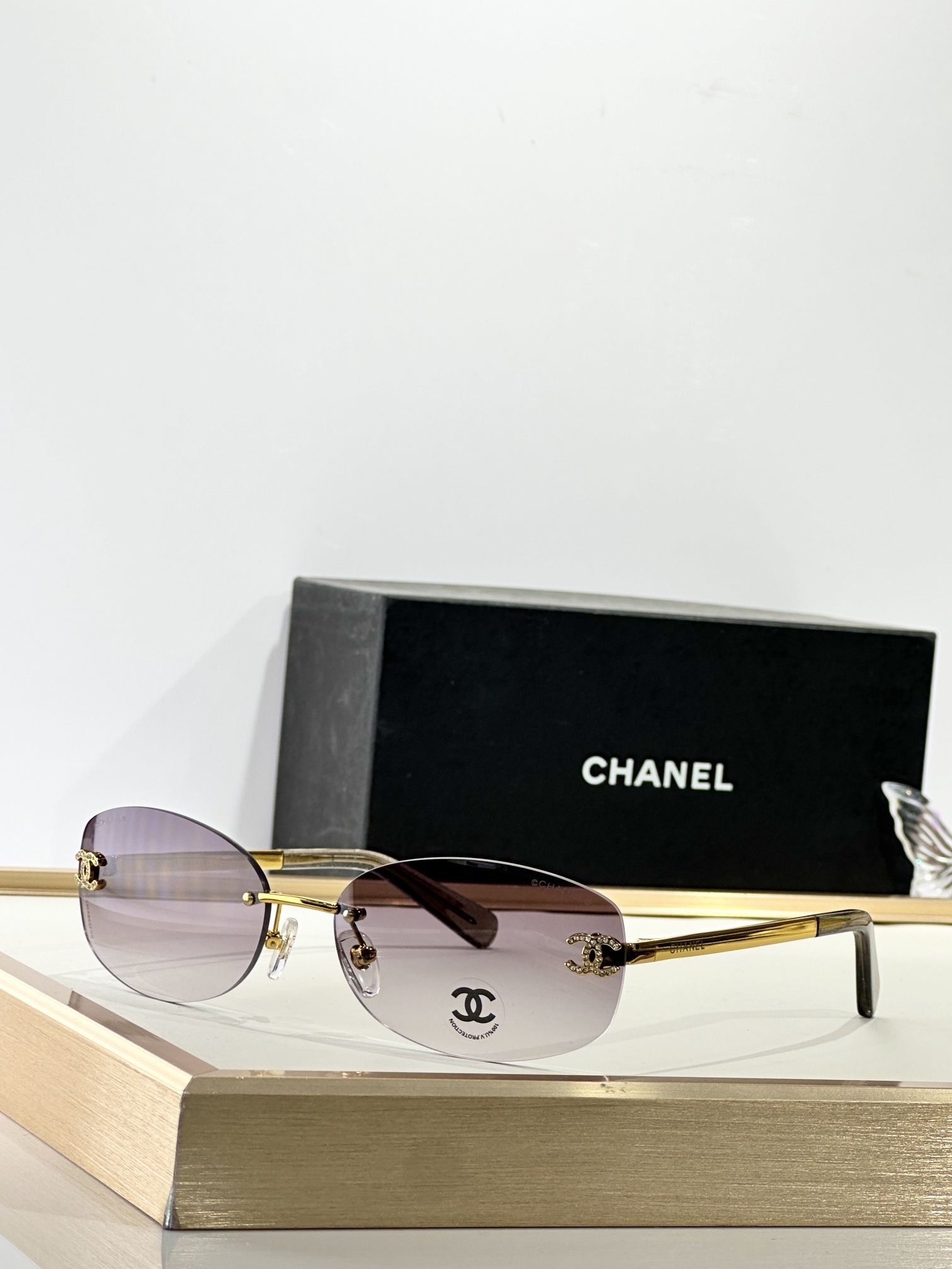 Chanel Rimless Oval Sunglasses with Rhinestone CC Logo - Brown