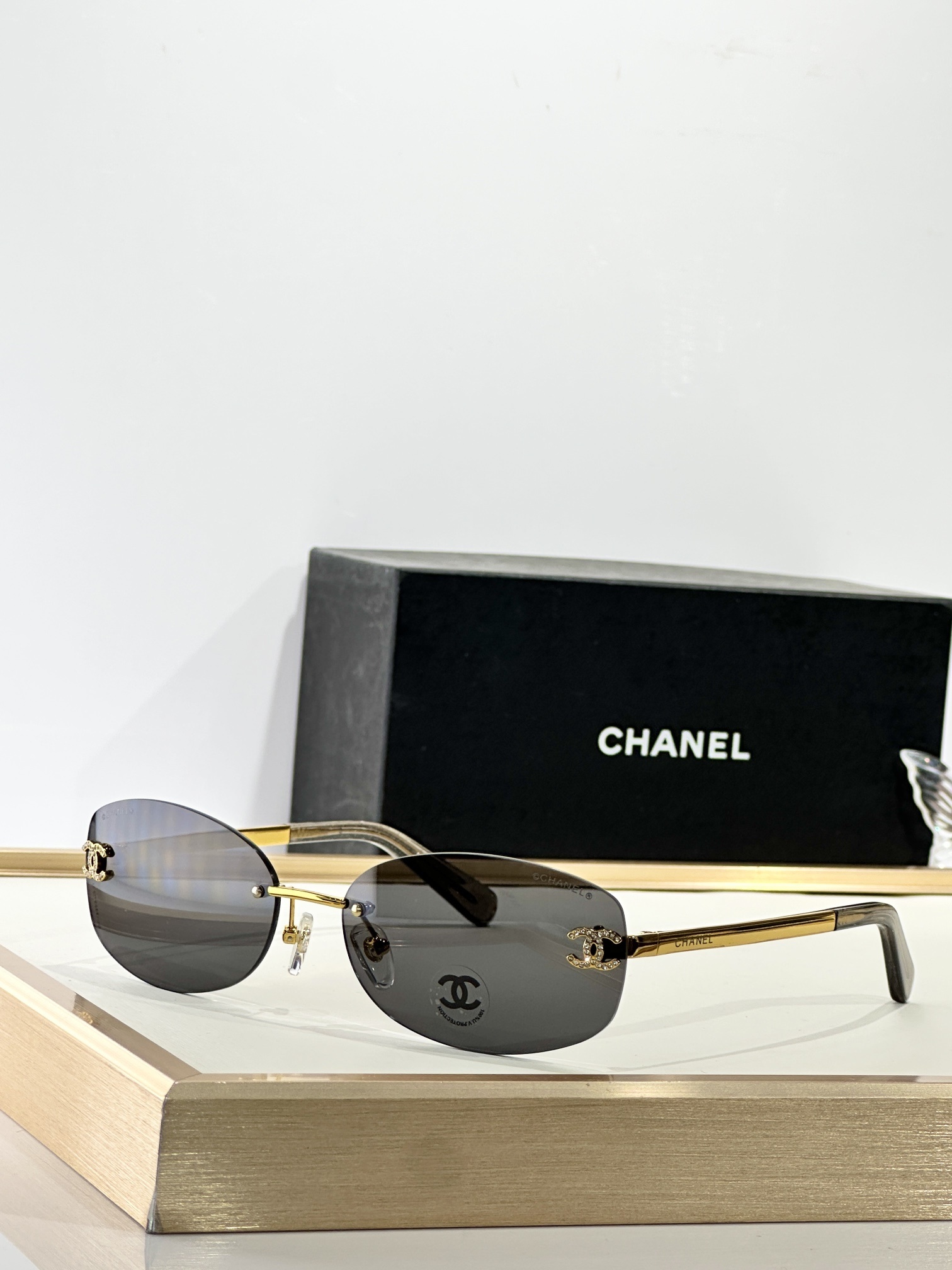 Chanel Rimless Oval Sunglasses with Rhinestone CC Logo - Brown