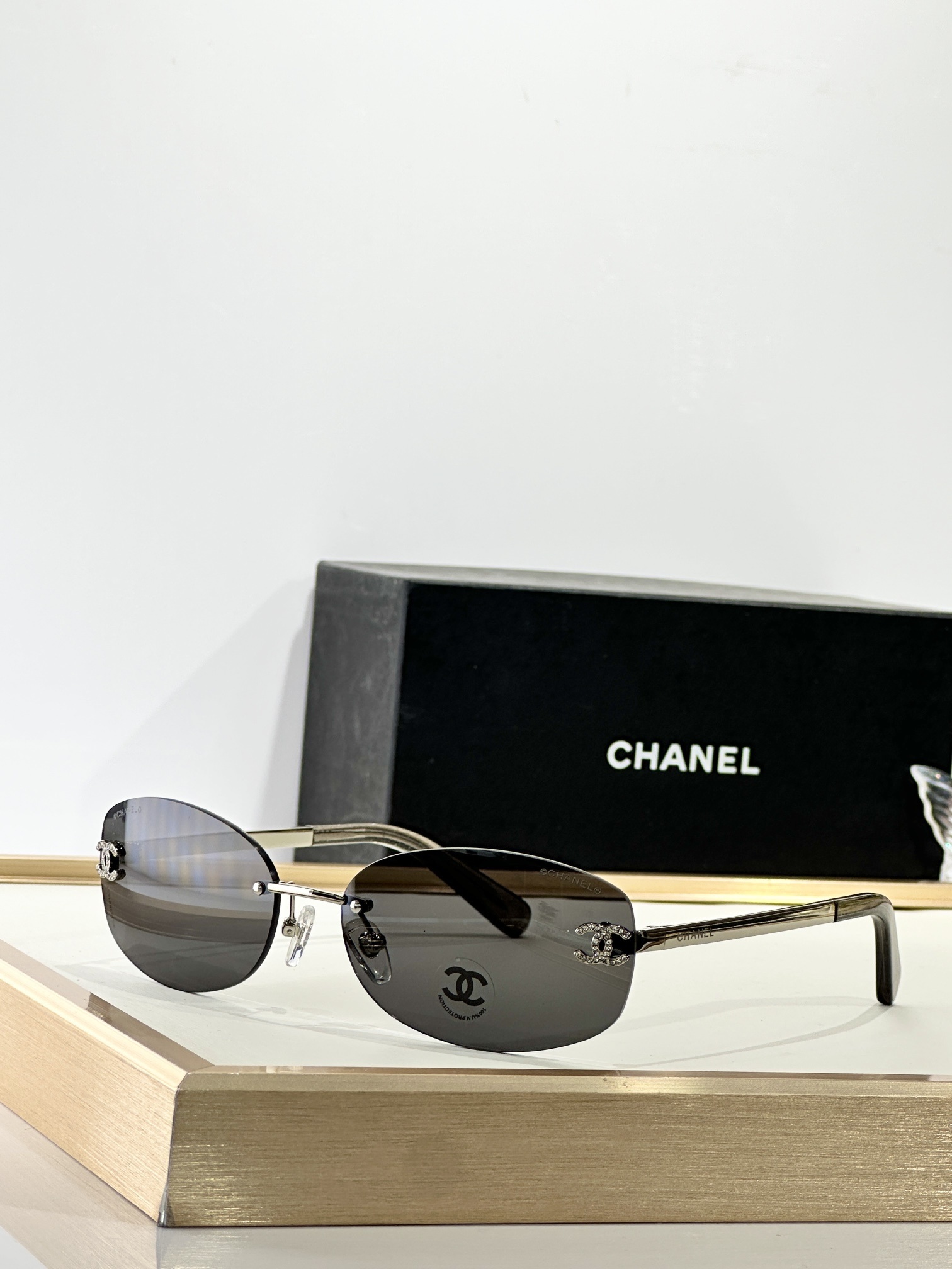 Chanel Rimless Oval Sunglasses with Rhinestone CC Logo - Brown