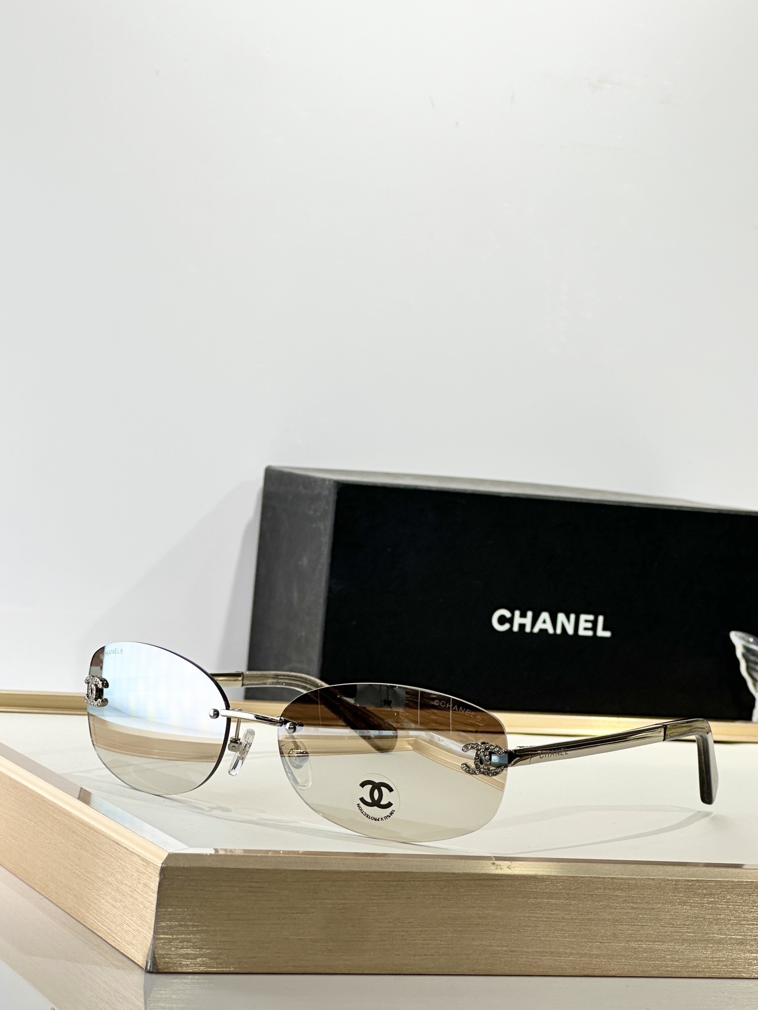 Chanel Rimless Oval Sunglasses with Rhinestone CC Logo - Brown