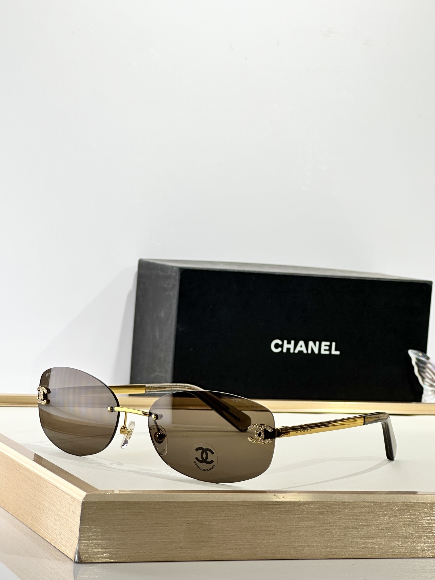 Chanel Rimless Oval Sunglasses with Rhinestone CC Logo - Brown