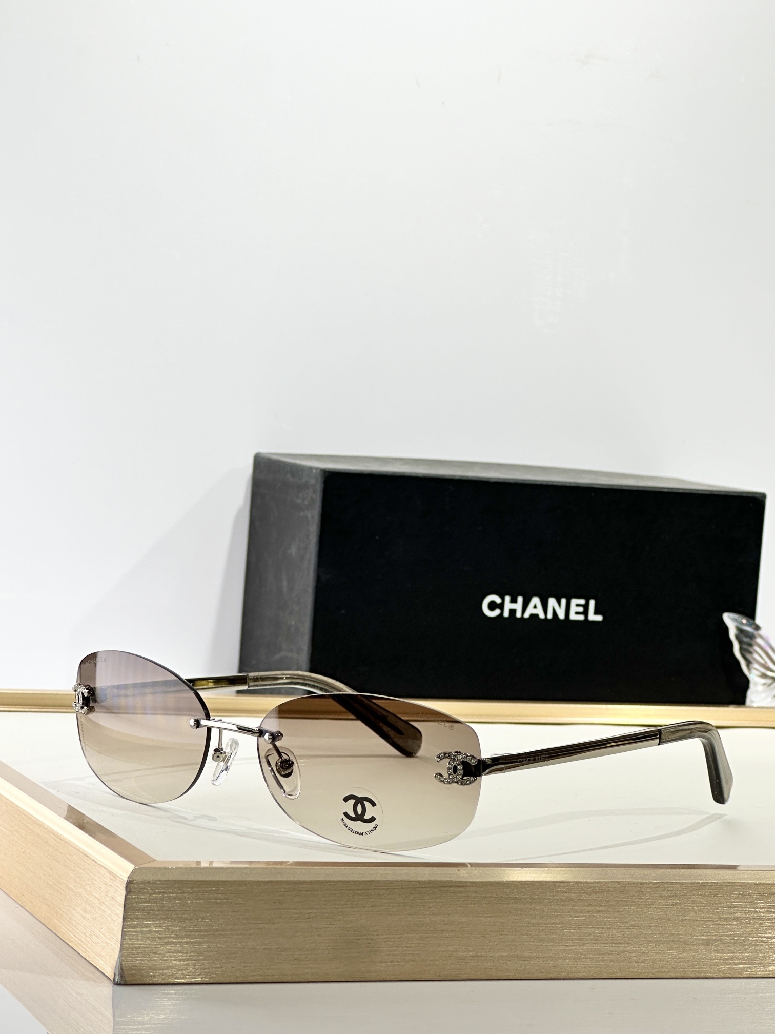 Chanel Rimless Oval Sunglasses with Rhinestone CC Logo – Brown