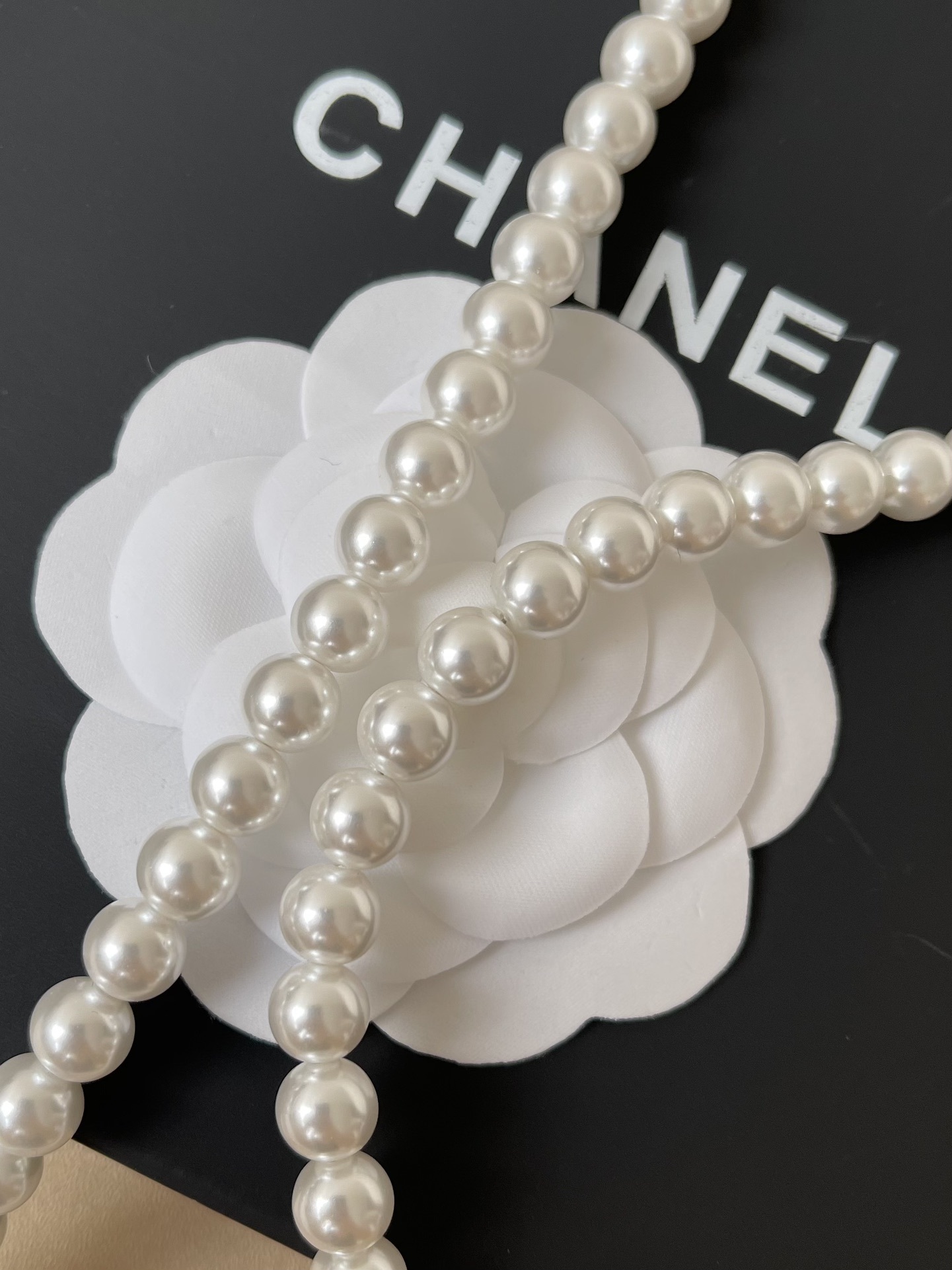 Elegant Long Pearl Necklace with Iconic CC Logo Pendant