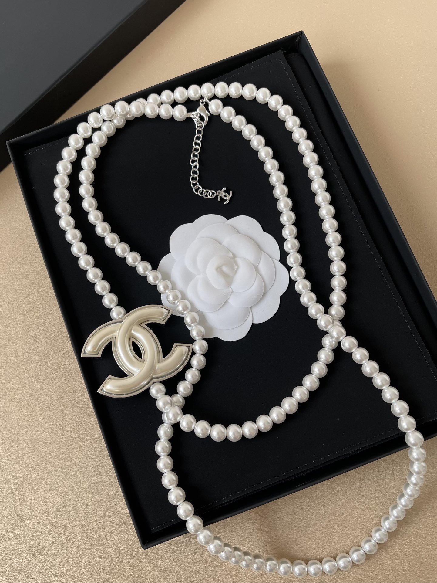 Elegant Long Pearl Necklace with Iconic CC Logo Pendant