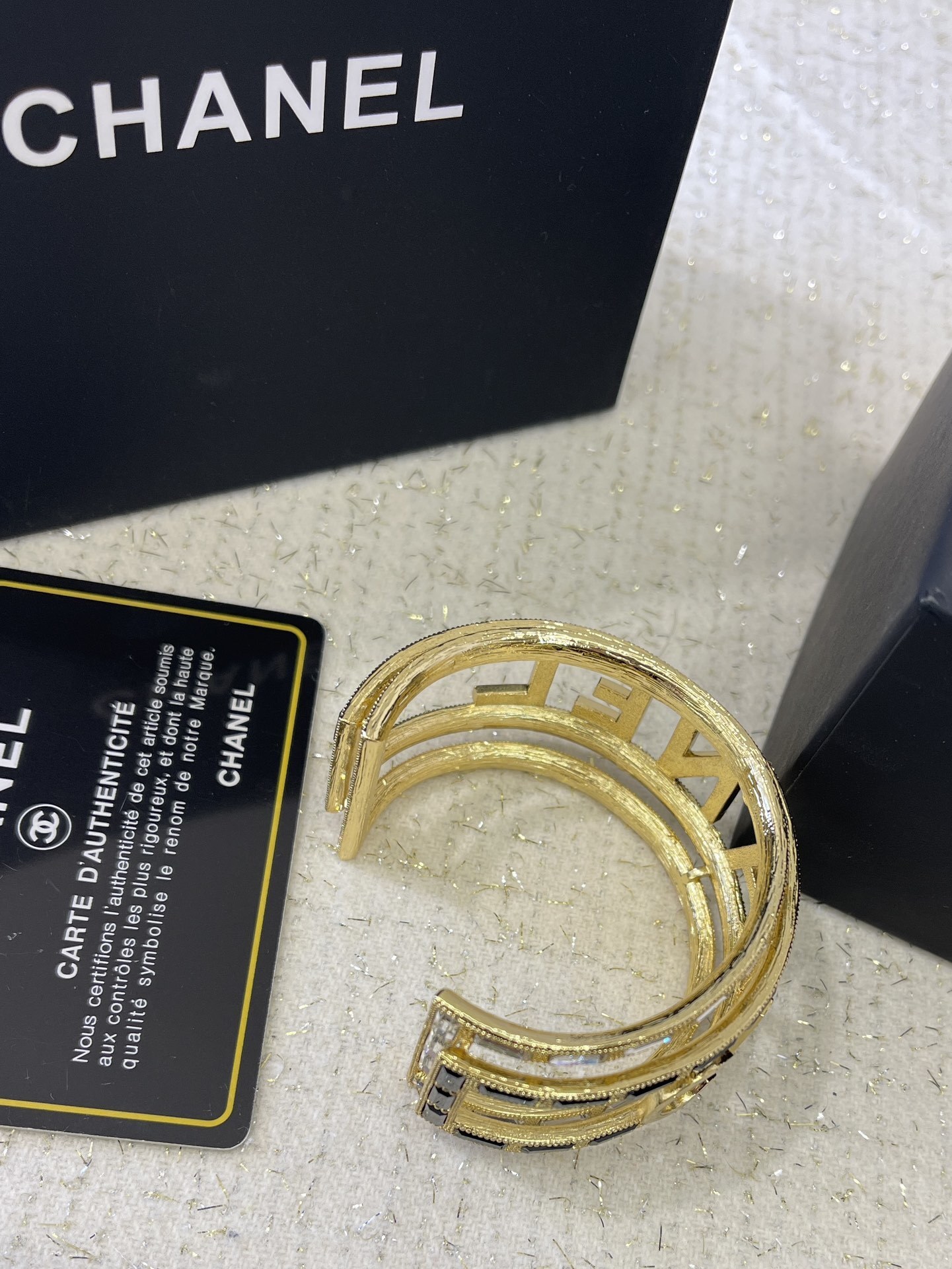 Luxury Chanel Gold-Tone Logo Cuff Bracelet with Black & White Stones