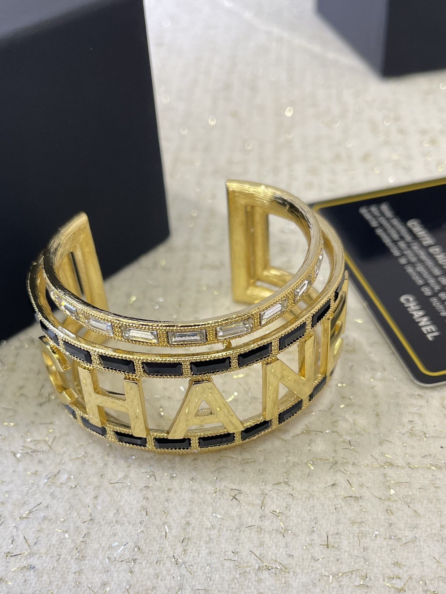 Luxury Chanel Gold-Tone Logo Cuff Bracelet with Black & White Stones