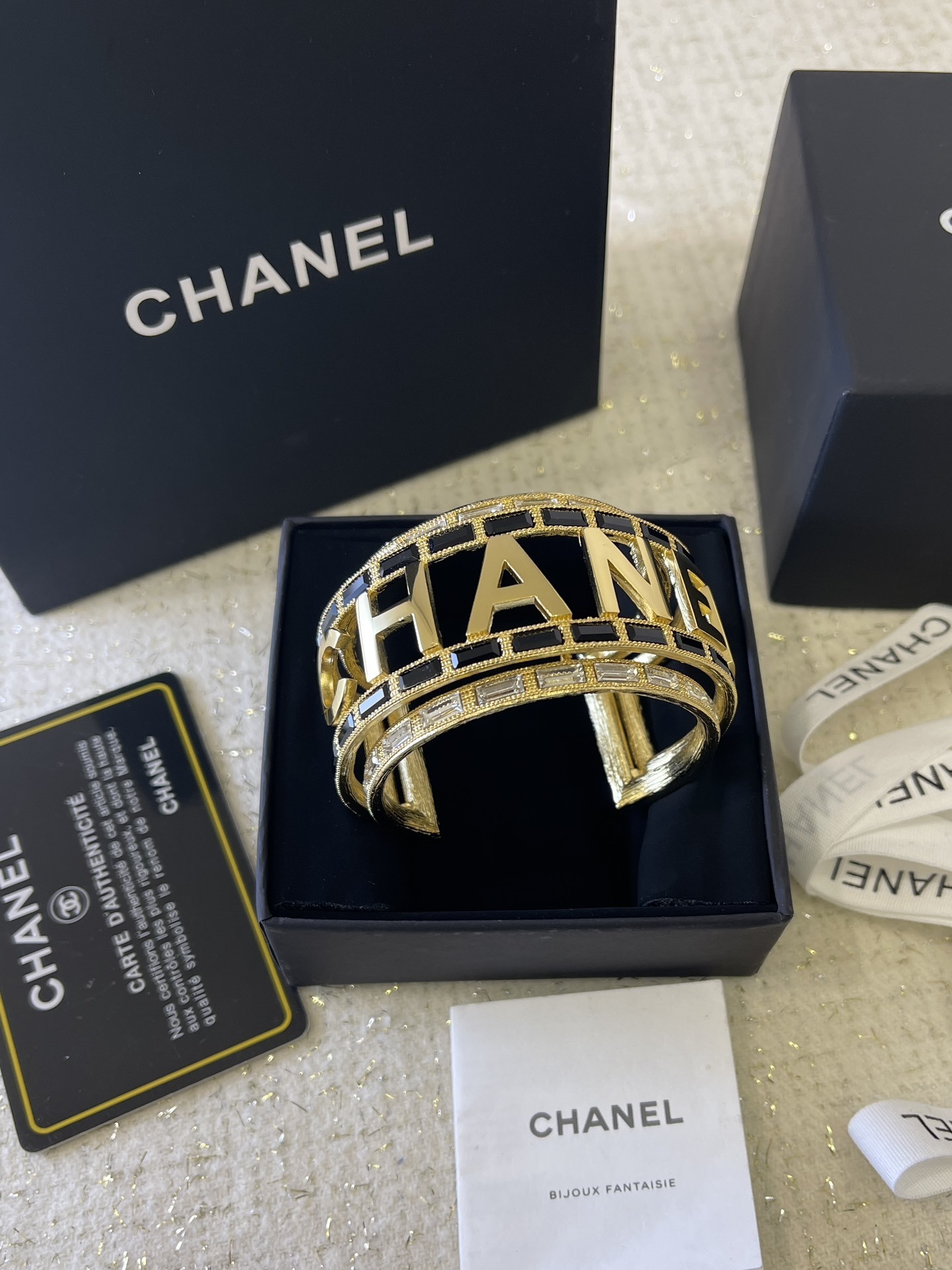 Luxury Chanel Gold-Tone Logo Cuff Bracelet with Black & White Stones