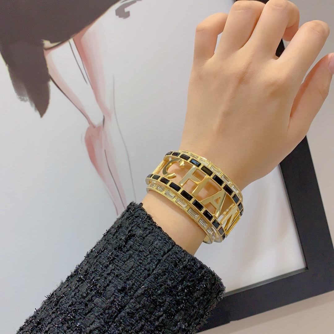 Luxury Chanel Gold-Tone Logo Cuff Bracelet with Black & White Stones