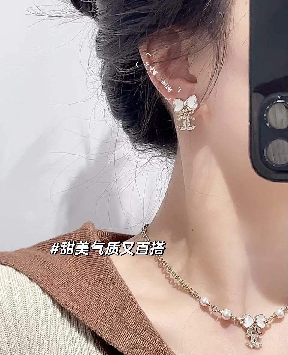 Elegant White Bow & Crystal Logo Dangle Earrings - Gold Tone