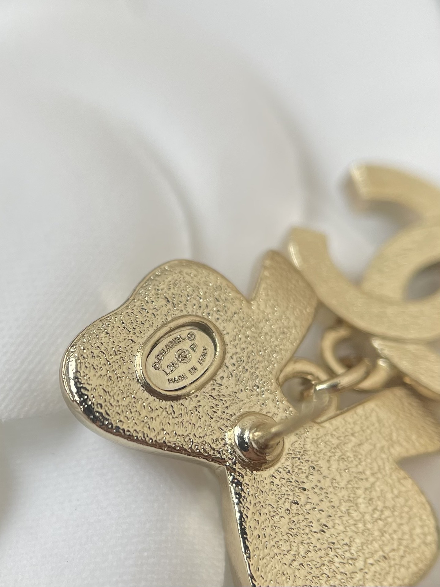 Elegant White Bow & Crystal Logo Dangle Earrings - Gold Tone