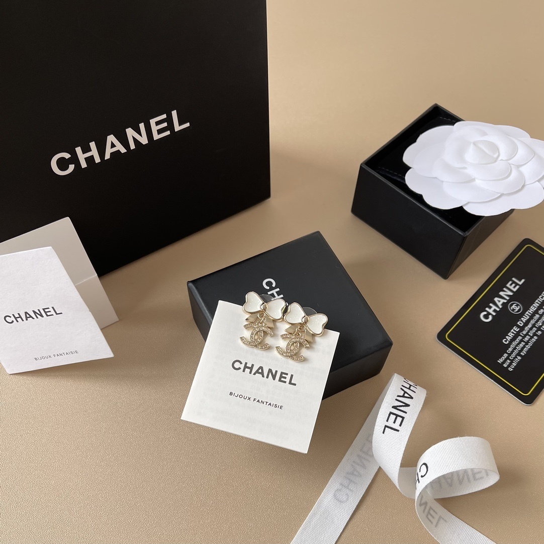 Elegant White Bow & Crystal Logo Dangle Earrings - Gold Tone