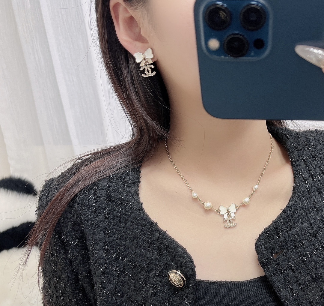 Elegant White Bow & Crystal Logo Dangle Earrings - Gold Tone