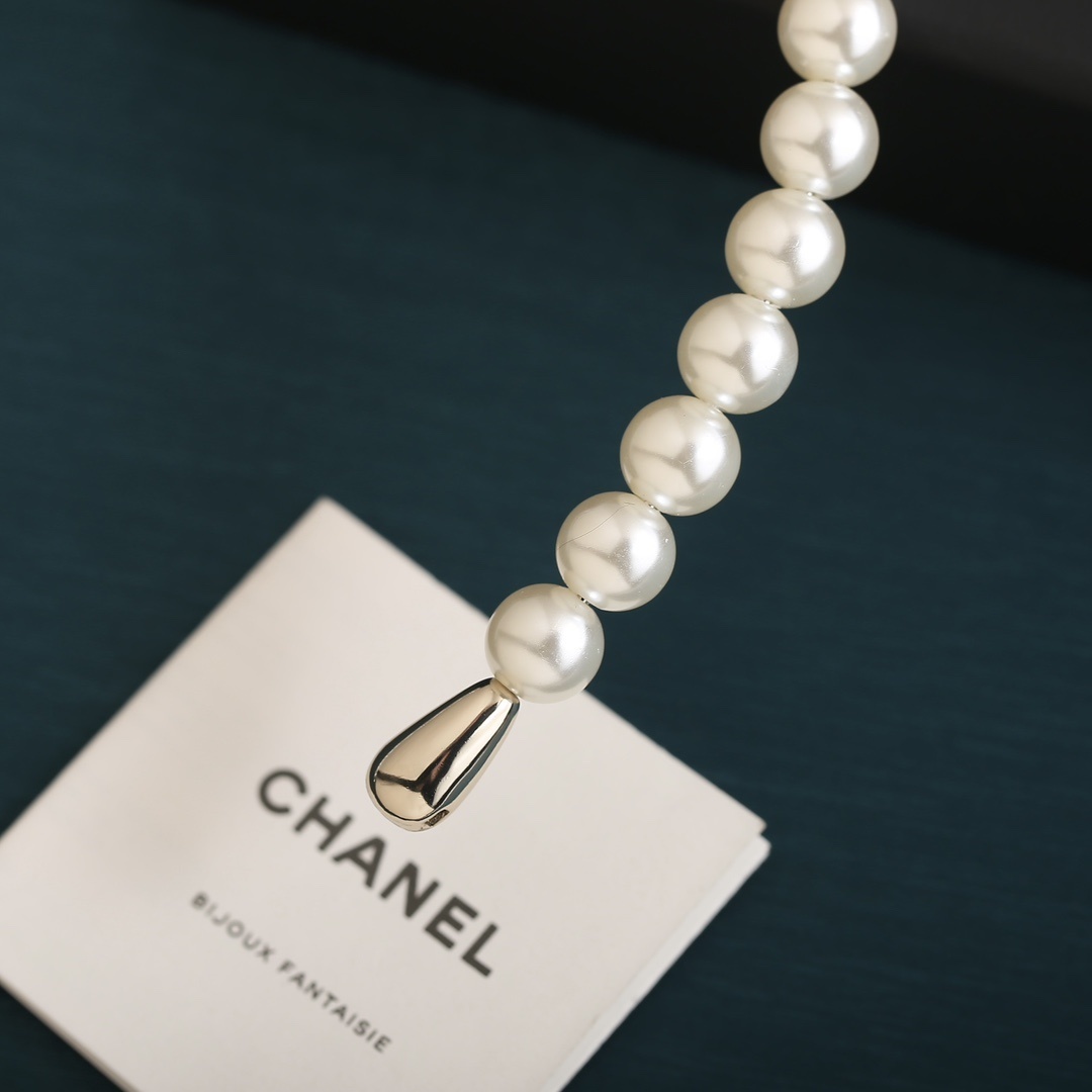 Elegant Pearl Headband with Black Ribbon Bow and Gold Detail