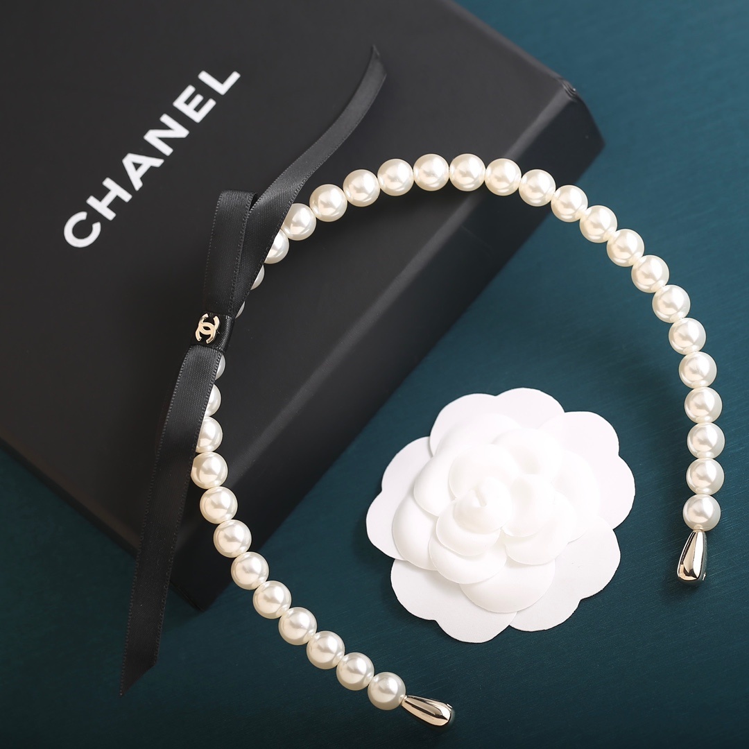 Elegant Pearl Headband with Black Ribbon Bow and Gold Detail