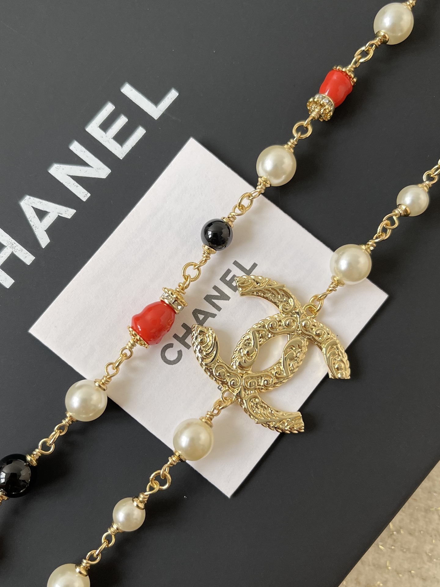 Elegant Gold CC Pearl Long Necklace - Red & Black Bead Detail