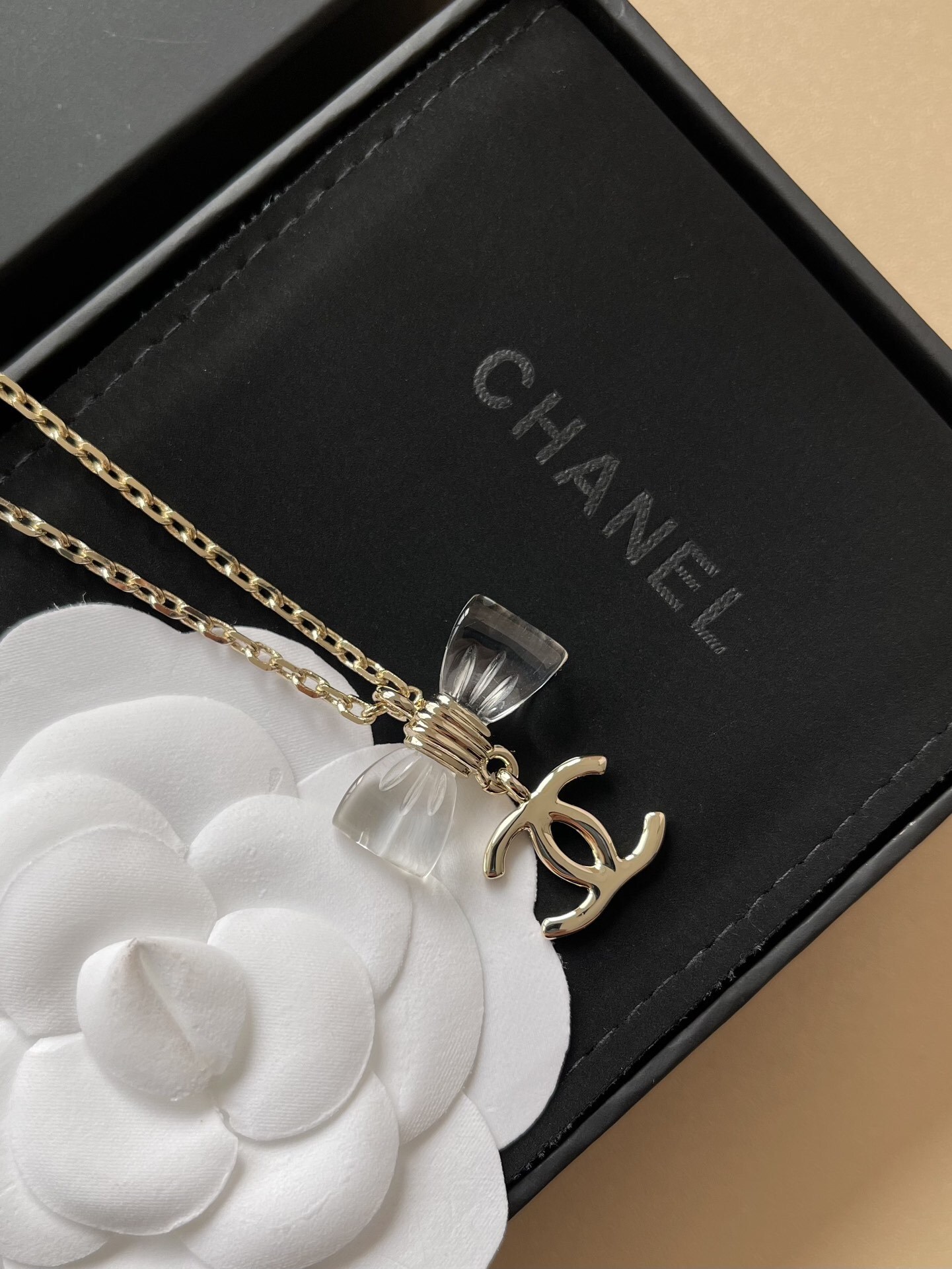 Elegant Gold-Tone Crystal Bow & CC Logo Pendant Necklace