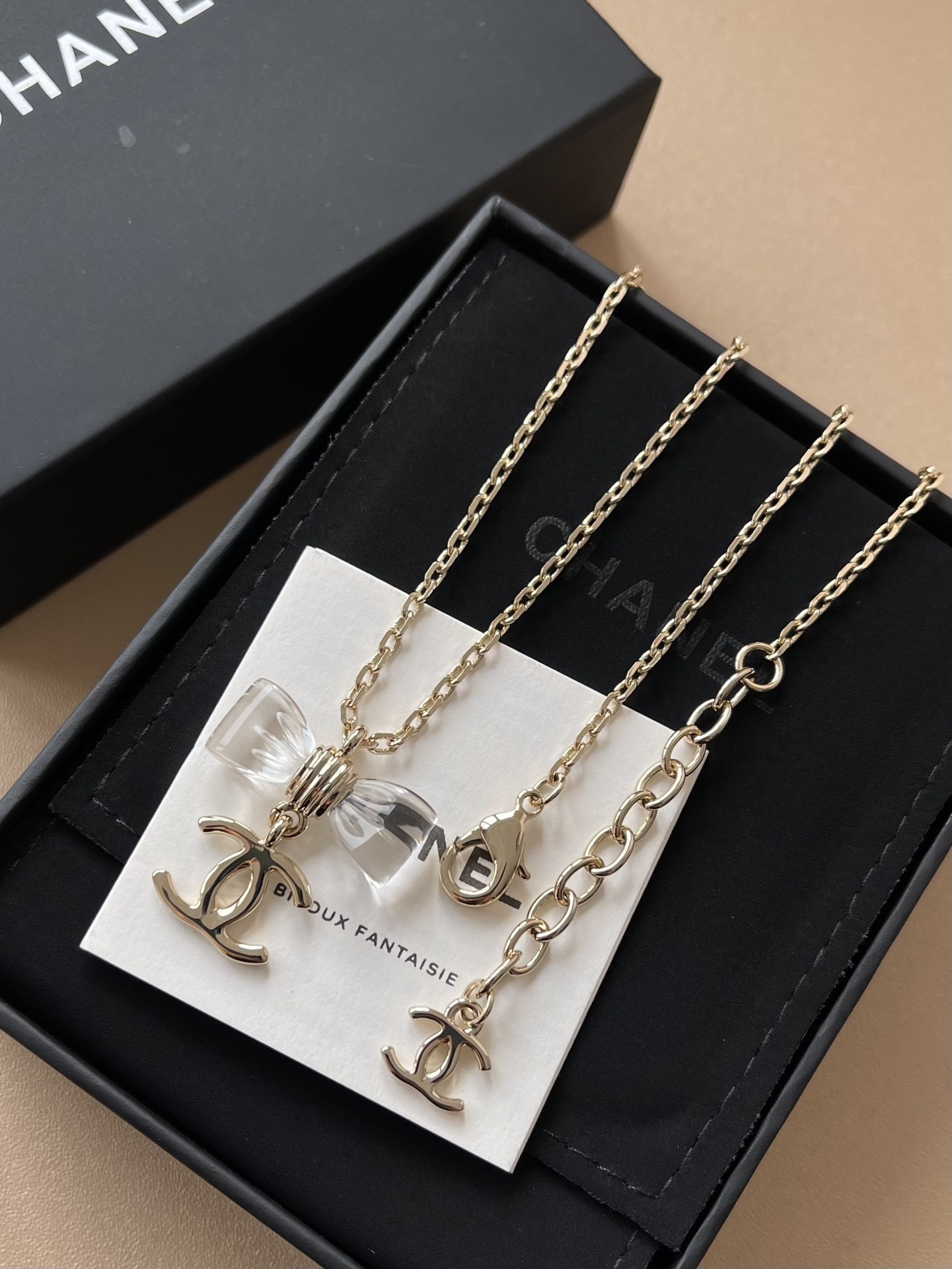 Elegant Gold-Tone Crystal Bow & CC Logo Pendant Necklace