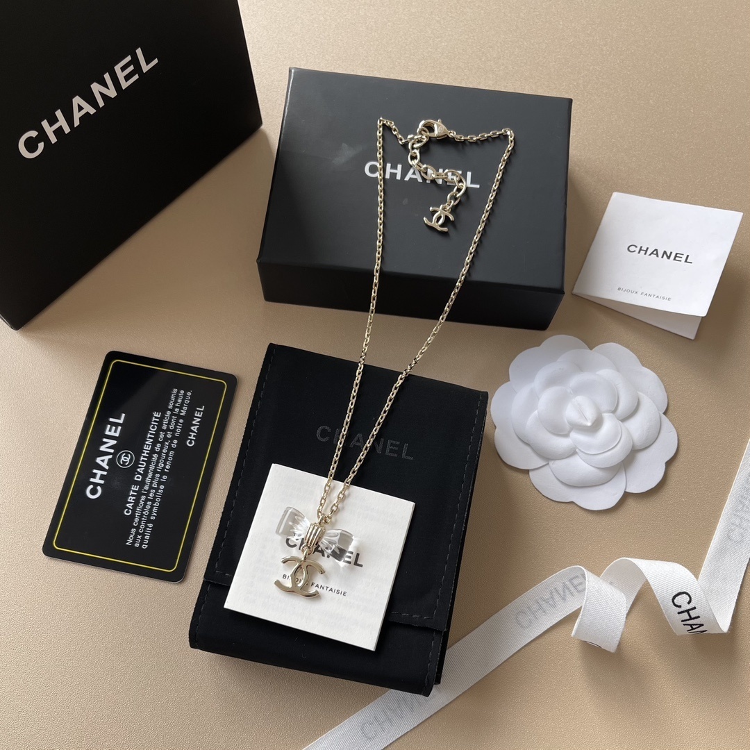 Elegant Gold-Tone Crystal Bow & CC Logo Pendant Necklace