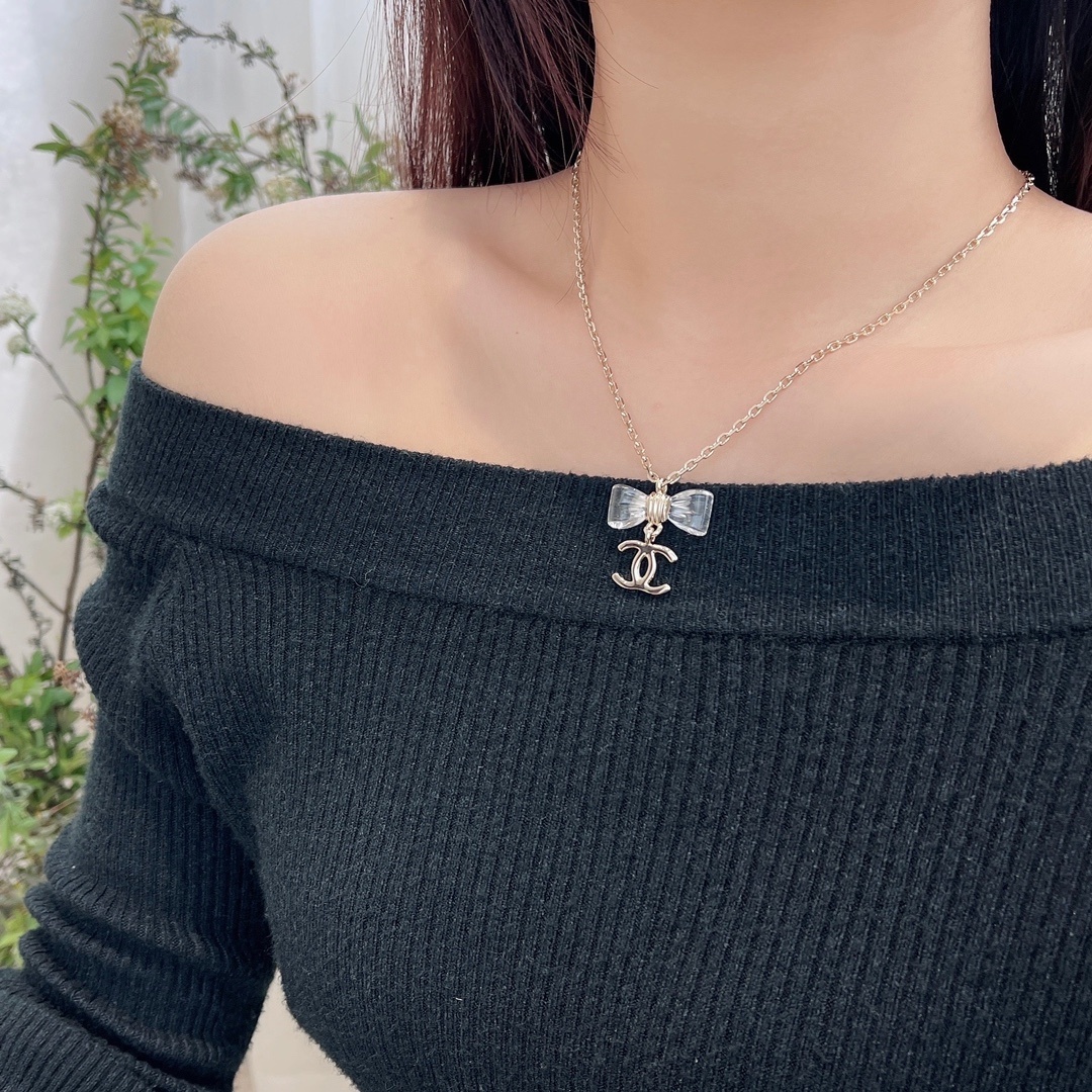 Elegant Gold-Tone Crystal Bow & CC Logo Pendant Necklace