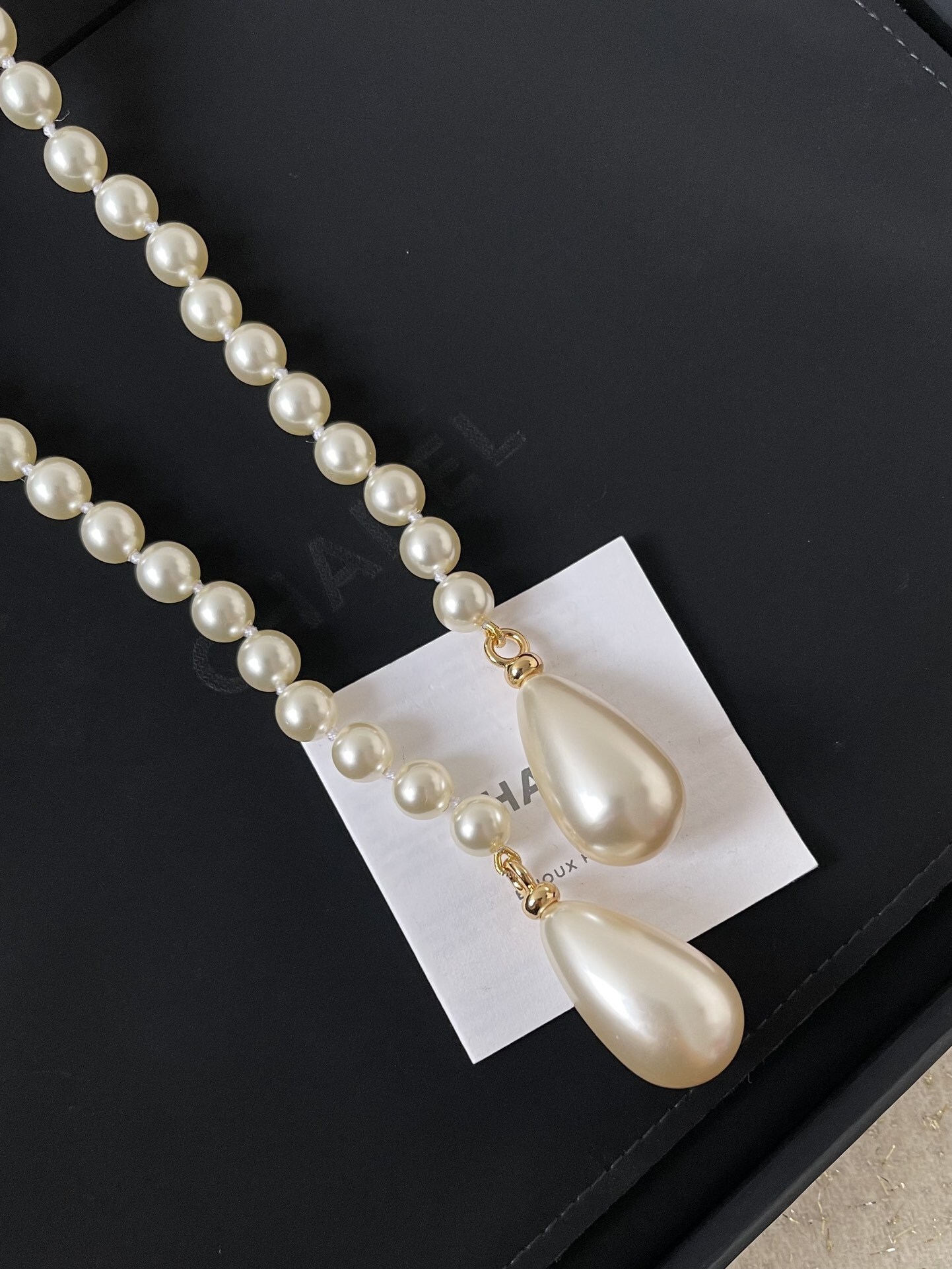 Elegant Long Pearl Necklace with Gold Safety Pin Logo Pendant