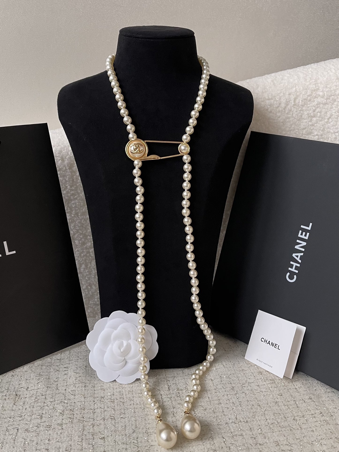 Elegant Long Pearl Necklace with Gold Safety Pin Logo Pendant