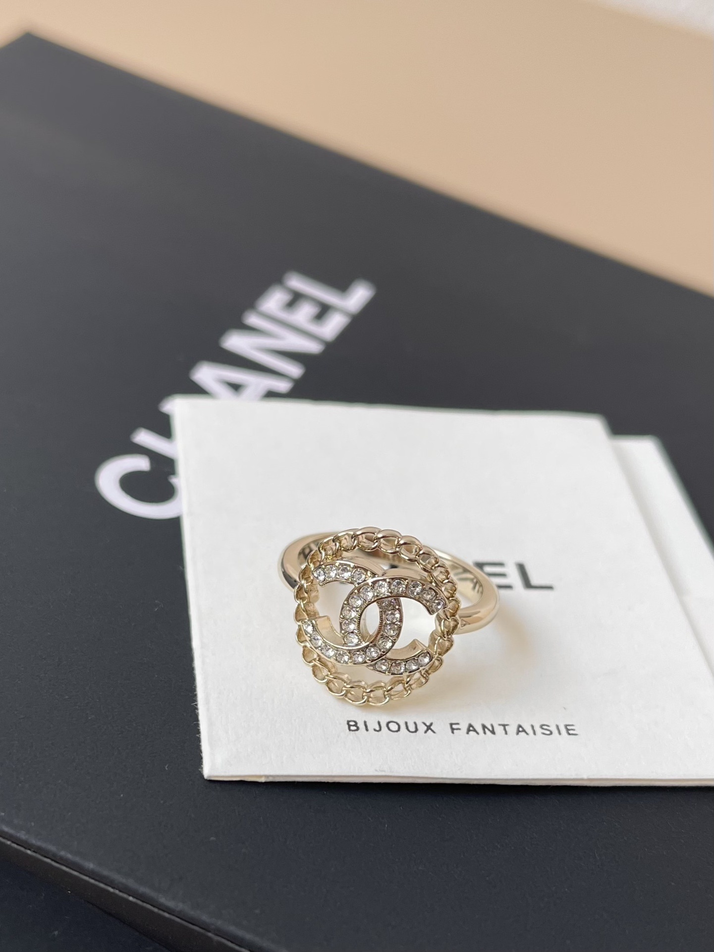 Chanel CC Logo Crystal Ring with Chain Border - Elegant Luxury