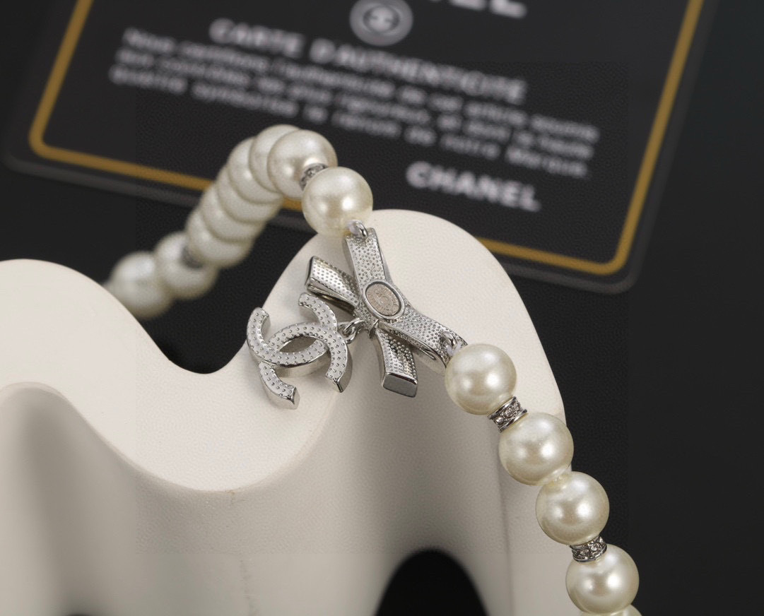 Chanel Elegant Pearl Necklace with Crystal Bow and CC Logo Charm
