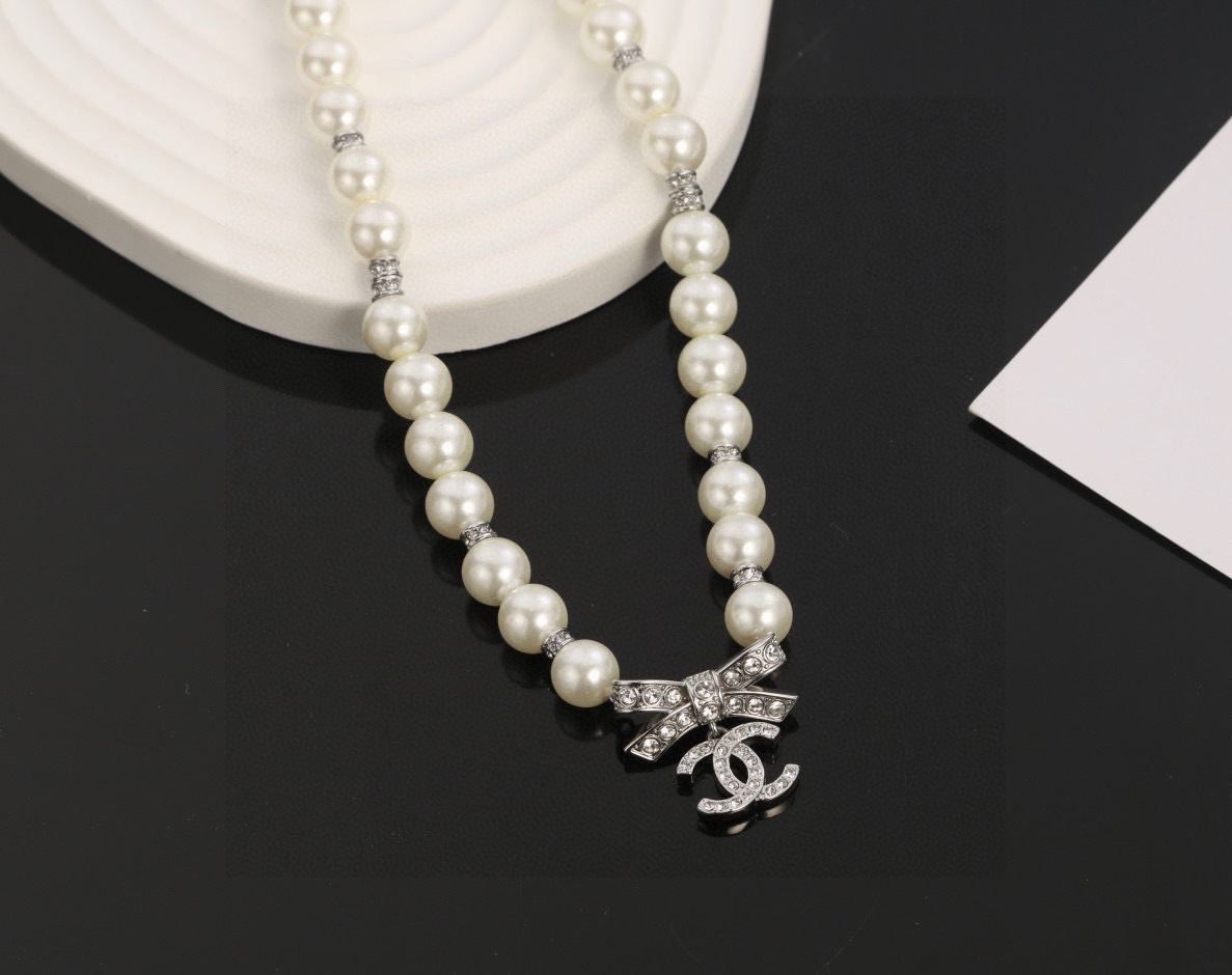 Chanel Elegant Pearl Necklace with Crystal Bow and CC Logo Charm