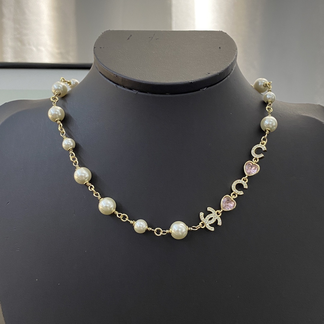 Elegant Gold Pearl Necklace with CC Charms and Pink Crystal Hearts